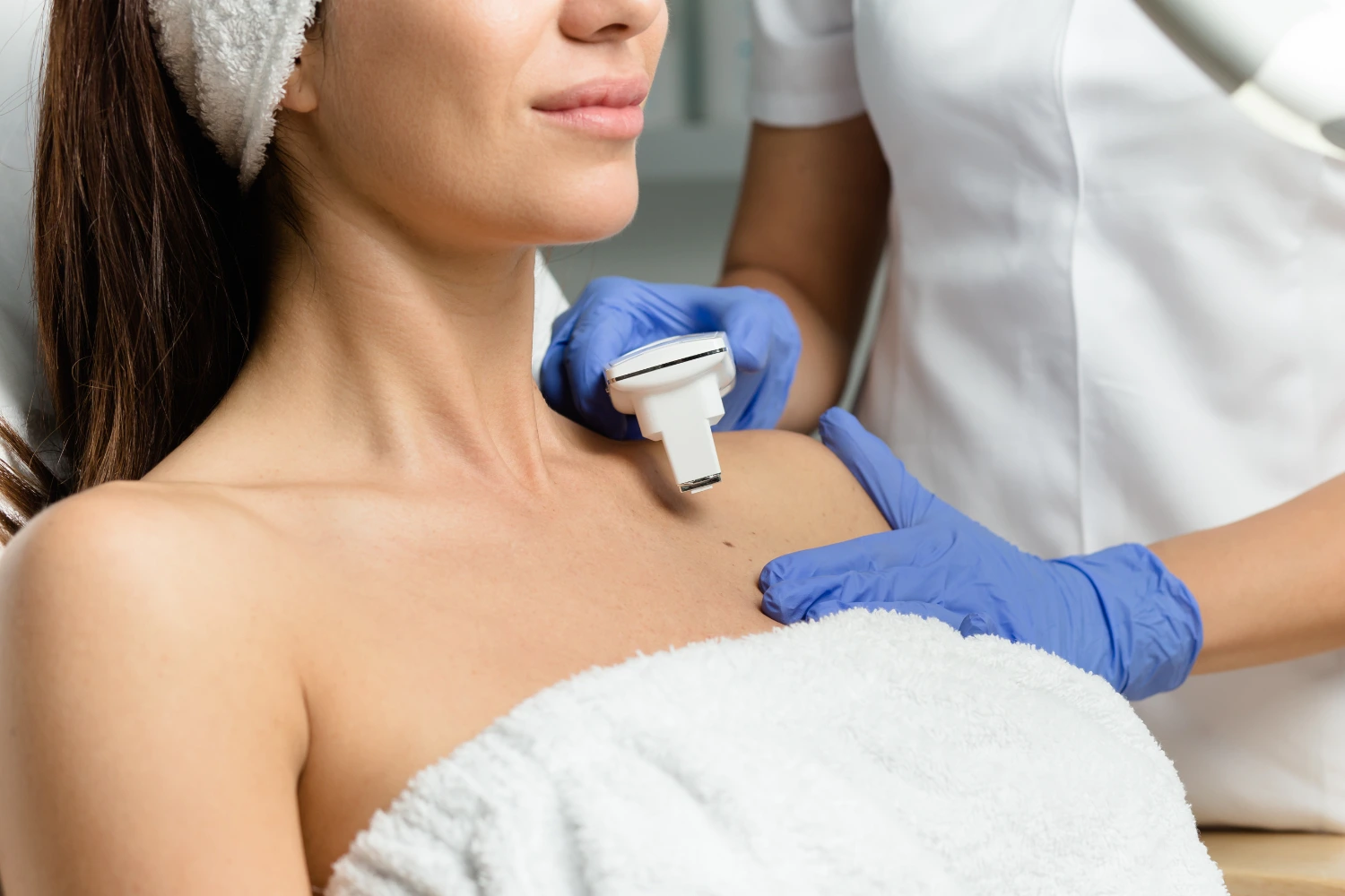 Lady undergoing Minor Skin Surgery treatment for mole removal at clinic.